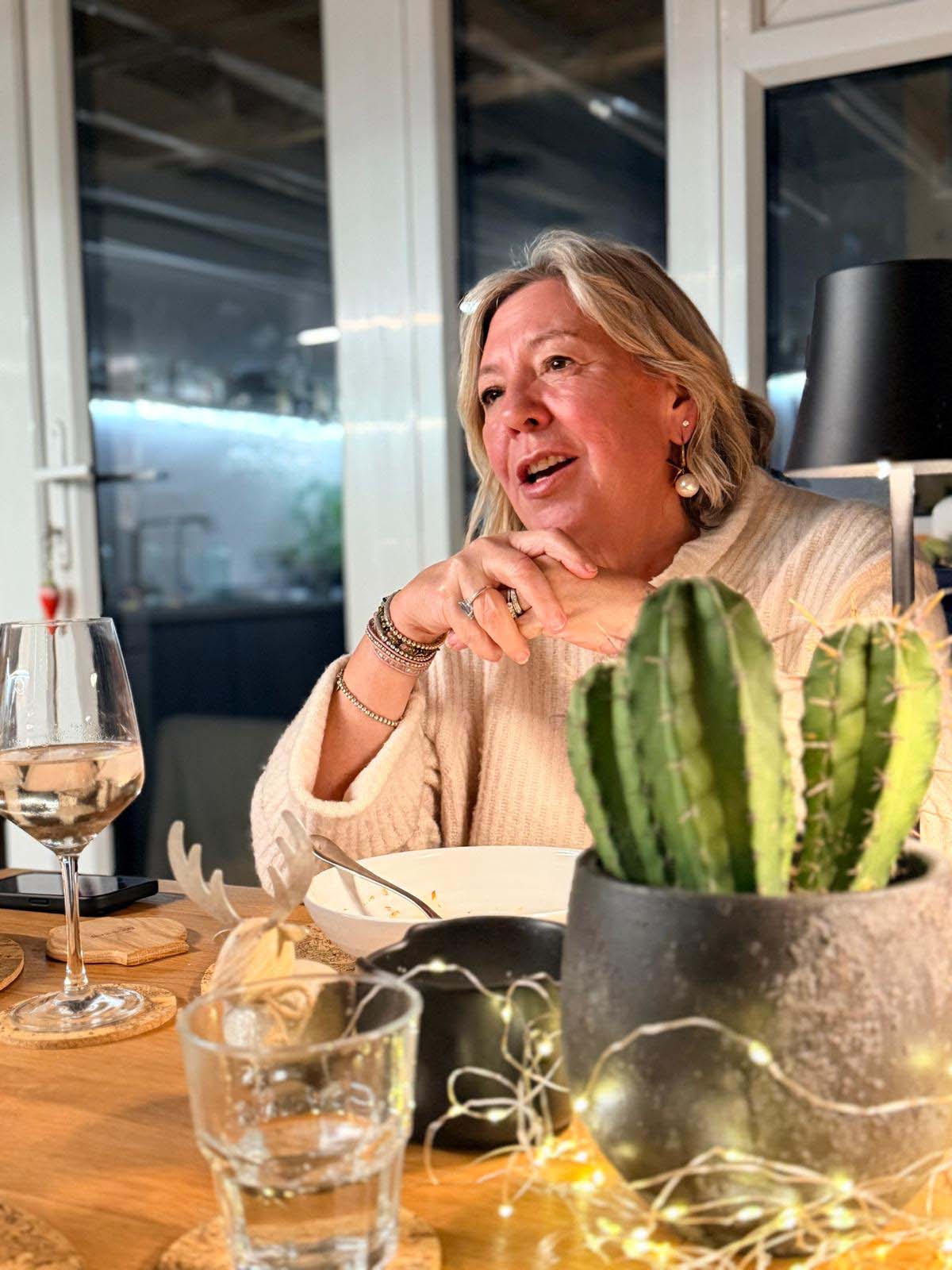 Jules chatting with guests at the table