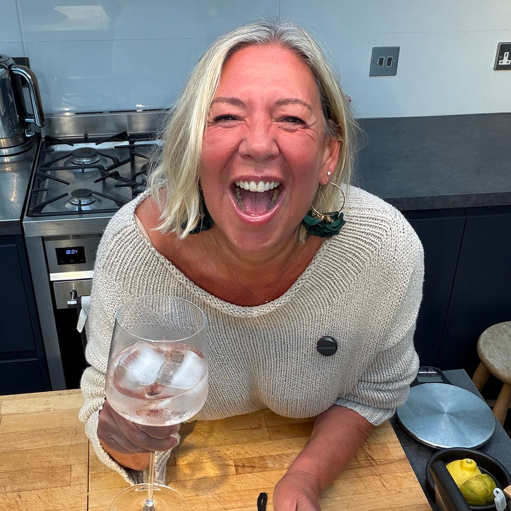 Jules with a glass of wine and a roast chicken